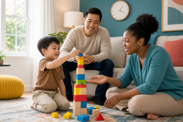 A calm 4-year-old child builds a colorful block tower with a female ABA therapist in a bright home living room while a father watches supportively from a sofa; a small wall clock appears in the background.
